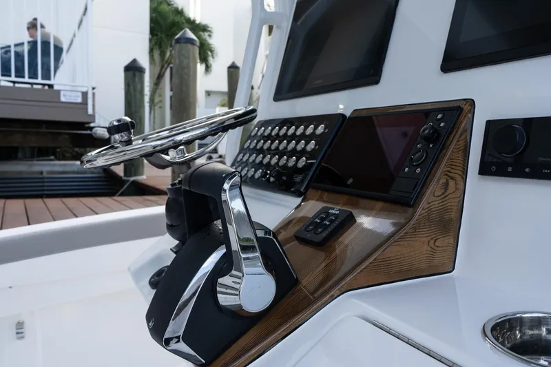 Slide: The Image of 2025 Caymas 291 HB boat dashboard with steering wheel and control panel. - 18