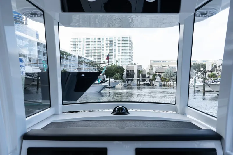 Slide: The Image of Interior view from 2025 Caymas 291 HB boat, overlooking marina with modern buildings. - 20