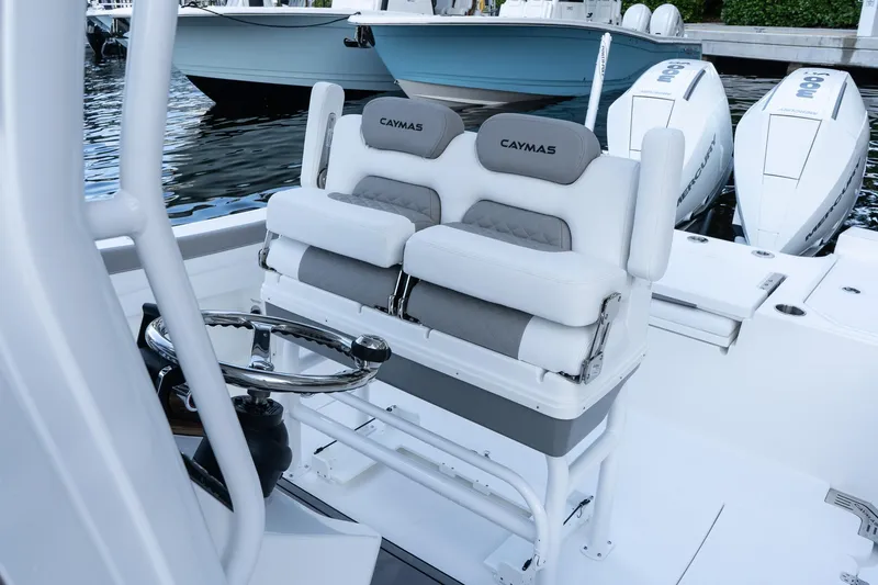 Slide: The Image of 2025 Caymas 291 HB boat interior with dual seats and steering wheel. - 23