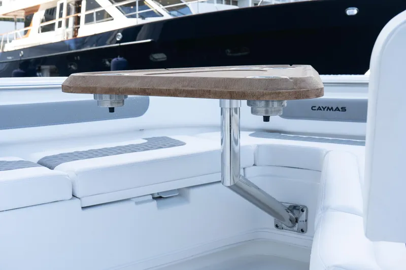 Slide: The Image of 2025 Caymas 291 HB boat interior with wooden table and cushioned seating. - 28