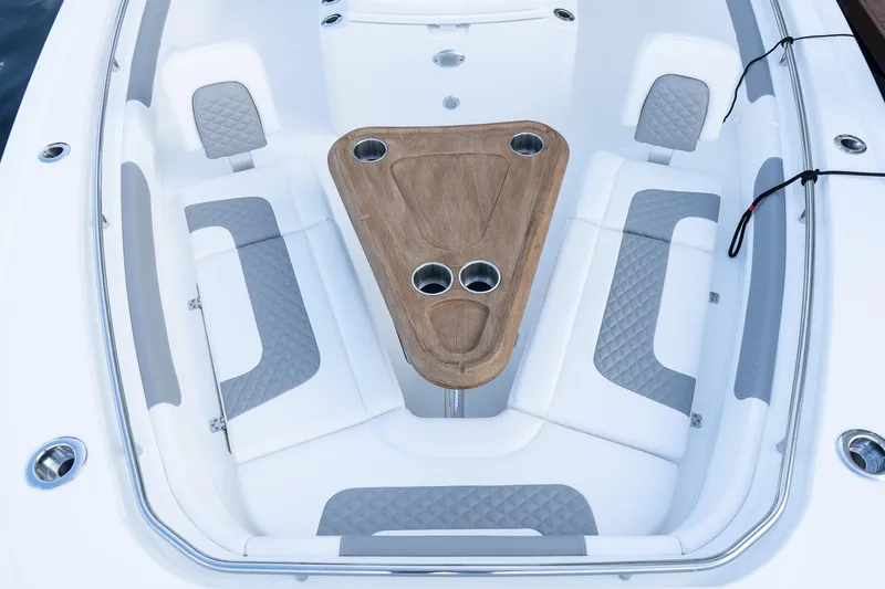 Slide: The Image of 2025 Caymas 291 HB boat interior with cushioned seating and wooden table. - 31
