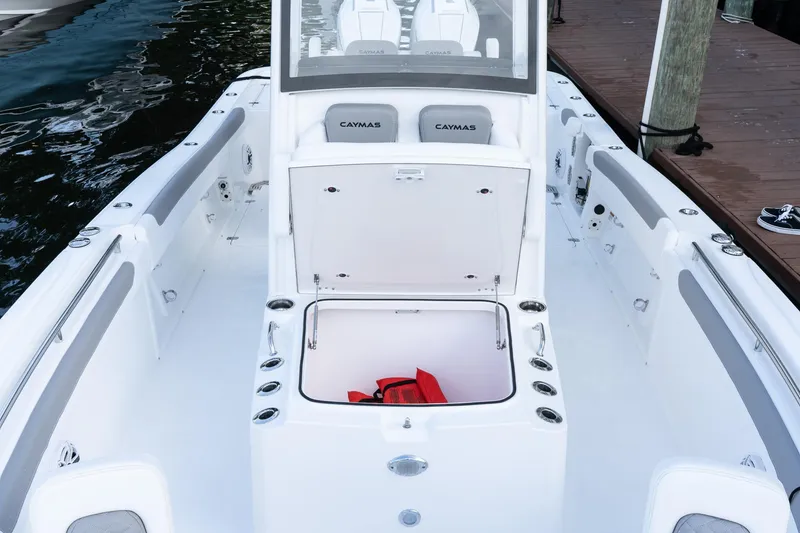 Slide: The Image of 2025 Caymas 291 HB boat interior with open storage compartment and seating. - 33