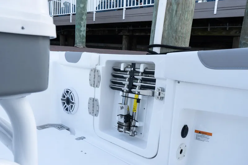 Slide: The Image of 2025 Caymas 291 HB boat interior showing storage compartment and speaker. - 34