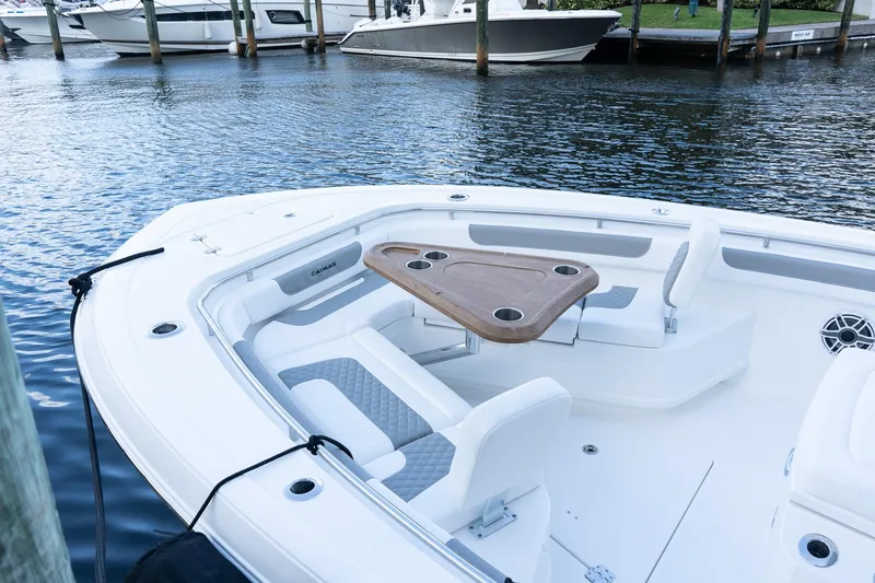 Slide: The Image of 2025 Caymas 291 HB boat with seating and table, docked in marina. - 37
