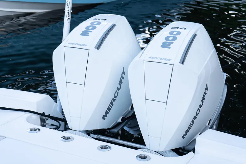 Slide: The Image of Twin Mercury outboard engines on 2025 Caymas 291 HB boat, docked on water. - 38
