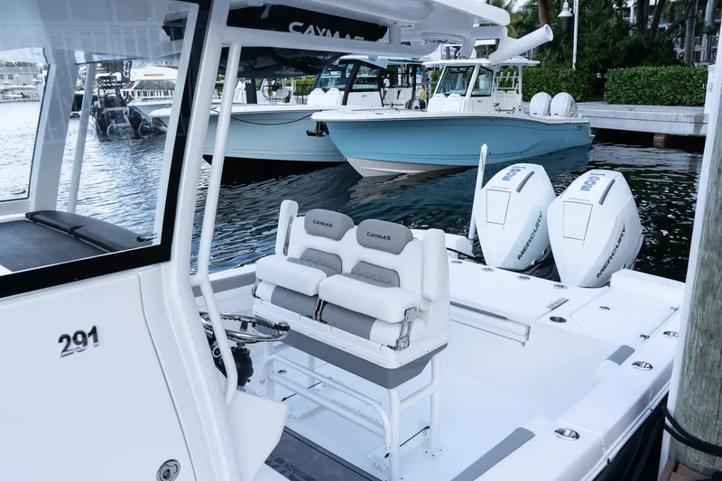 Slide: The Image of 2025 Caymas 291 HB boat with dual Mercury engines docked at marina. - 4