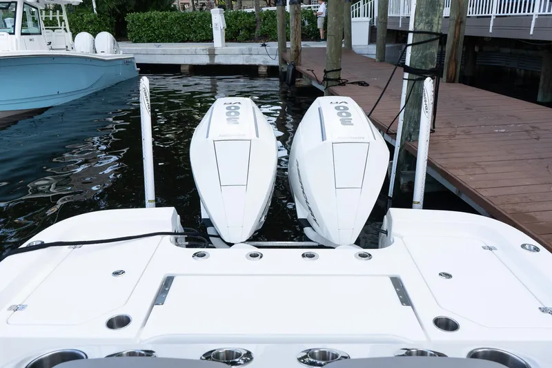 Slide: The Image of 2025 Caymas 291 HB boat with dual outboard engines docked at marina. - 5