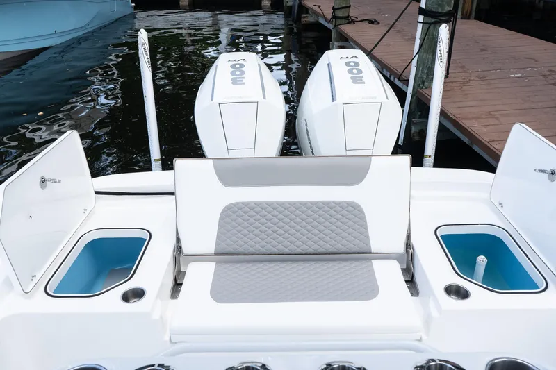 Slide: The Image of 2025 Caymas 291 HB boat with dual engines and cushioned seating at the dock. - 7