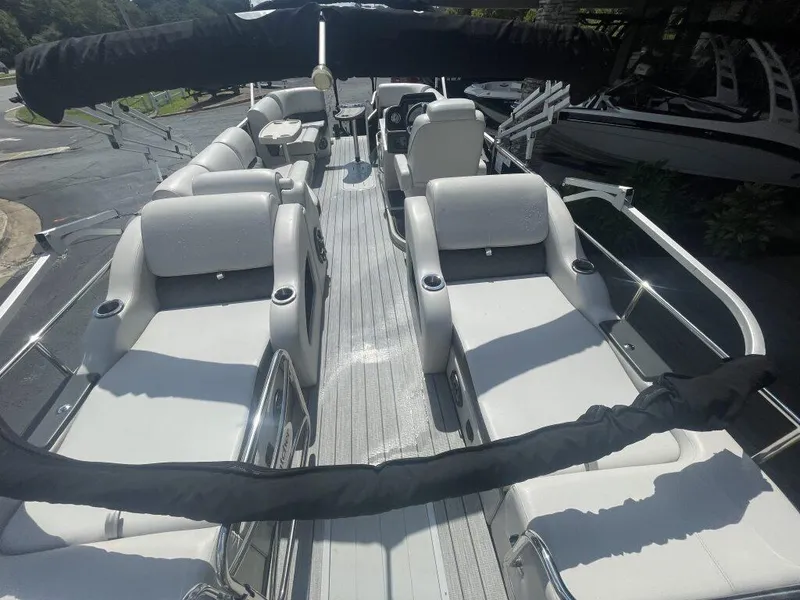 Slide: The Image of 2023 G3 SunCatcher Elite 324 SS pontoon boat interior with luxurious seating and cup holders. - 6