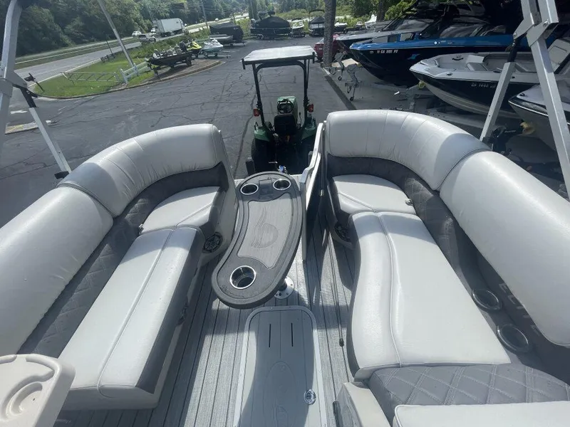 Slide: The Image of 2023 G3 SunCatcher Elite 324 SS pontoon boat interior with plush seating and cup holders. - 9