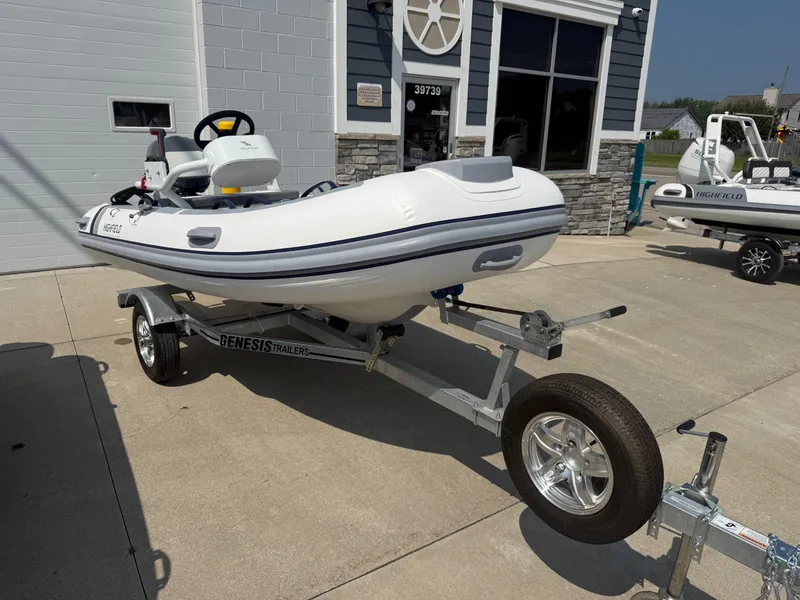 Slide: The Image of 2024 Highfield Classic 360 FCT boat on Genesis trailer outside a building. - 4