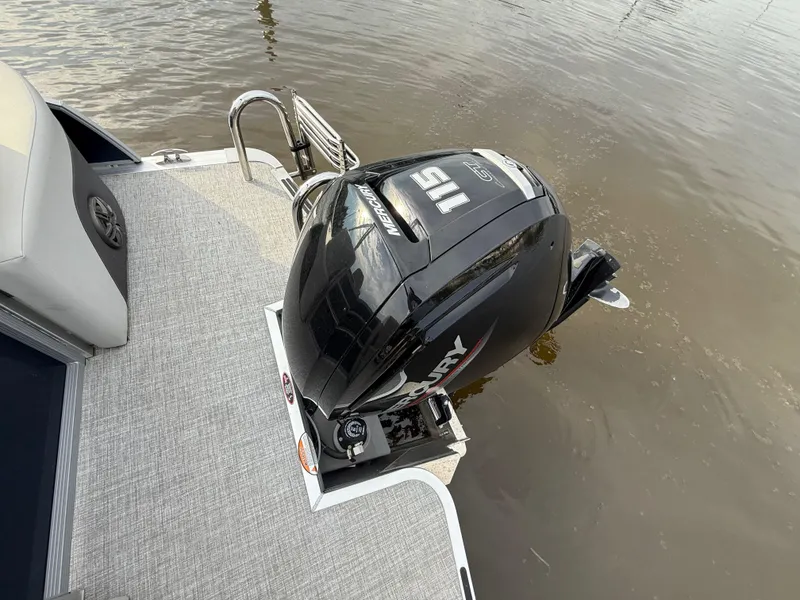 Slide: The Image of 2024 Harris Cruiser 230 with Mercury 115 outboard motor on water. - 6