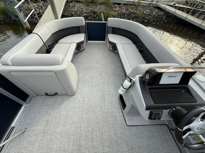 Slide: The Image of 2024 Harris Cruiser 230 pontoon boat interior with spacious seating and modern helm. - 8