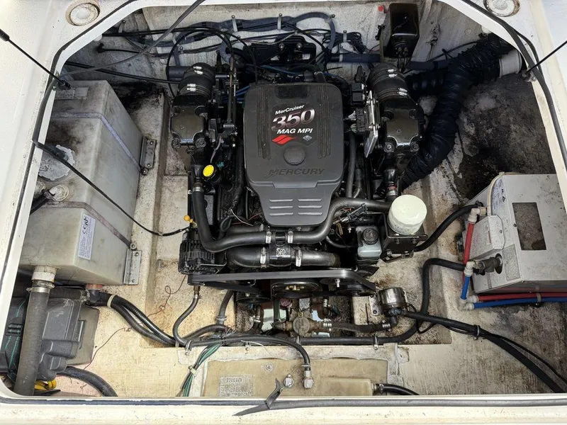 Slide: The Image of Engine compartment of a 2006 Larson 240 Cabrio boat, featuring a MerCruiser 350 MAG MPI engine. - 17