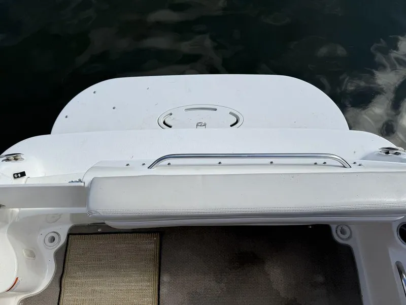 Slide: The Image of Rear deck of a 2006 Larson 240 Cabrio boat, featuring a white swim platform. - 18
