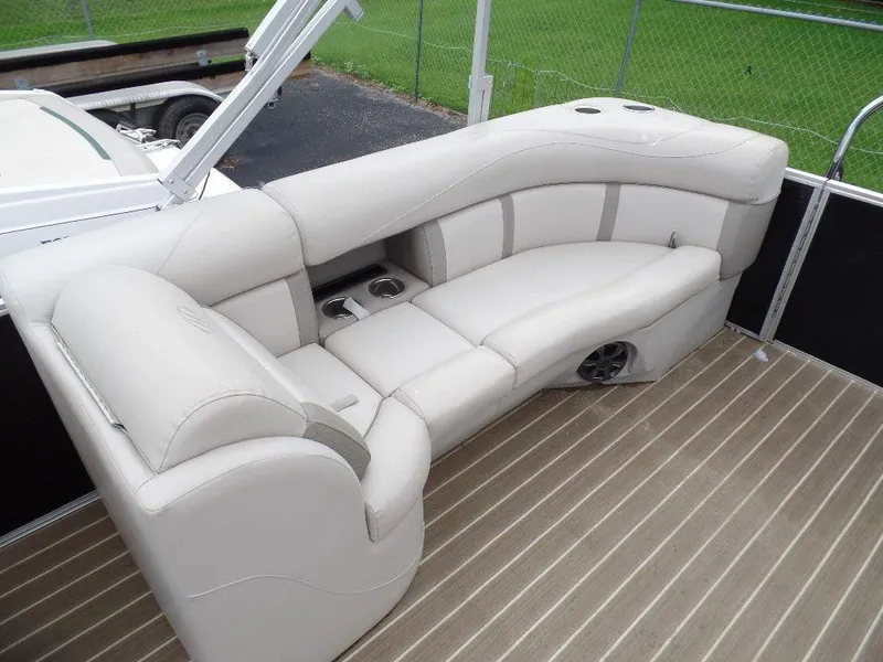 Slide: The Image of 2018 Harris Cruiser 240 boat interior with beige seating and cup holders. - 10