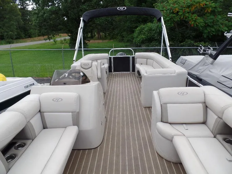 Slide: The Image of 2018 Harris Cruiser 240 pontoon boat with spacious seating and sleek design. - 6