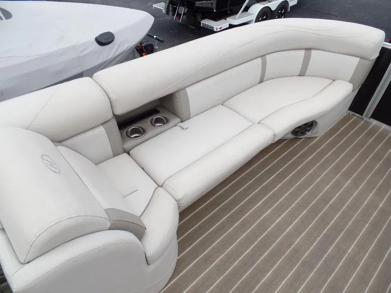 Slide: The Image of Luxurious seating on 2018 Harris Cruiser 240 boat, featuring cup holders and striped flooring. - 8