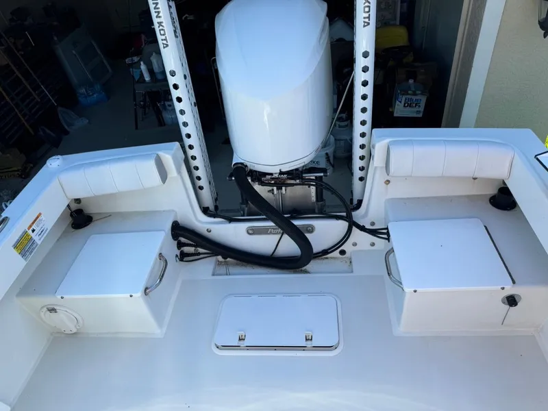 Slide: The Image of 2022 Parker 2300 Special Edition boat with Minn Kota motor in a garage setting. - 13