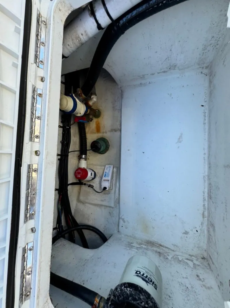 Slide: The Image of Bilge compartment of 2022 Parker 2300 Special Edition boat with hoses and fittings. - 16