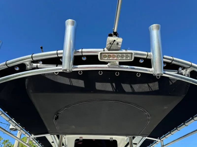 Slide: The Image of 2022 Parker 2300 Special Edition boat canopy with rod holders and light, under clear blue sky. - 18