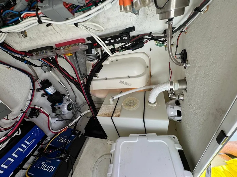 Slide: The Image of Interior view of 2022 Parker 2300 Special Edition boat's wiring and equipment setup. - 9