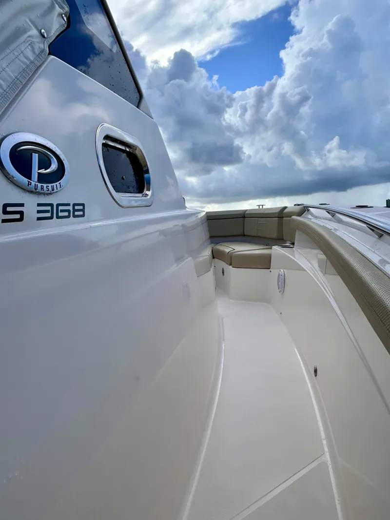 Slide: The Image of 2018 Pursuit S 368 Sport boat with sleek design under cloudy sky. - 10