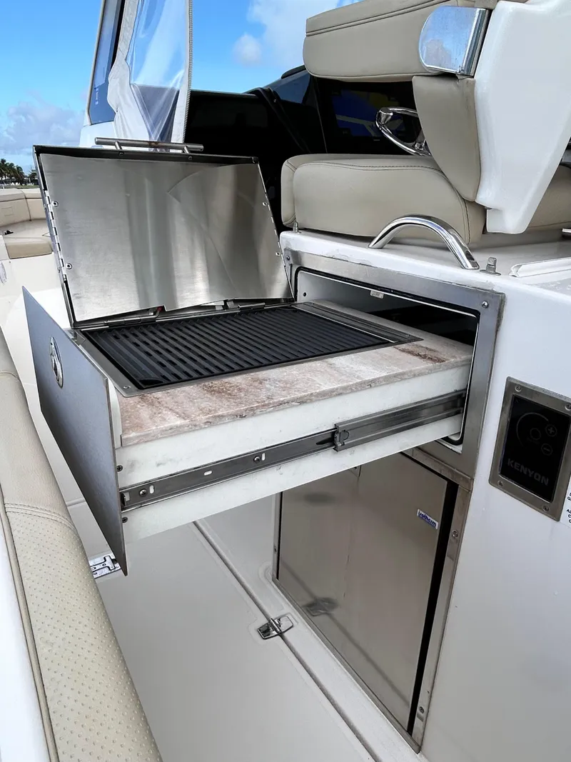 Slide: The Image of Built-in grill on 2018 Pursuit S 368 Sport boat, featuring stainless steel design. - 18