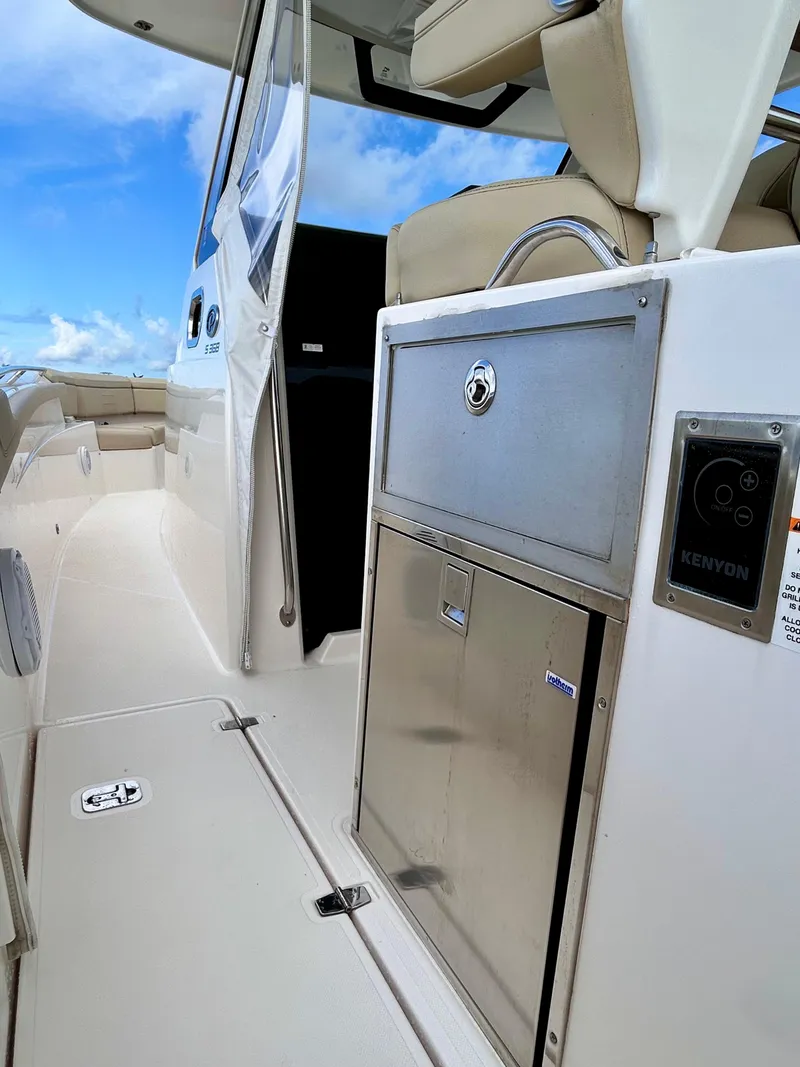 Slide: The Image of 2018 Pursuit S 368 Sport boat interior with stainless steel features and seating. - 19