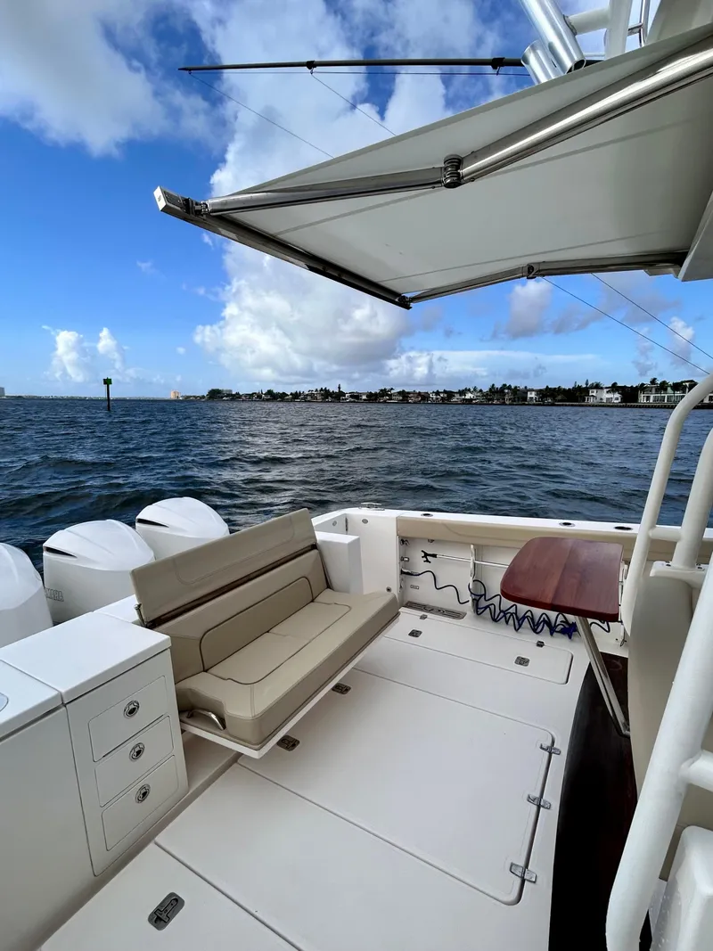 Slide: The Image of 2018 Pursuit S 368 Sport boat with seating and awning on open water. - 22