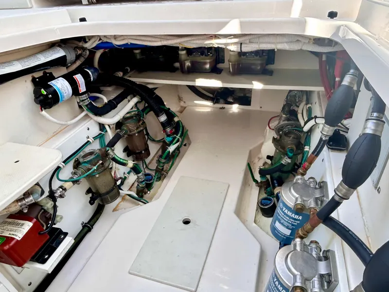 Slide: The Image of Engine compartment of a 2018 Pursuit S 368 Sport boat, showcasing mechanical components and filters. - 23