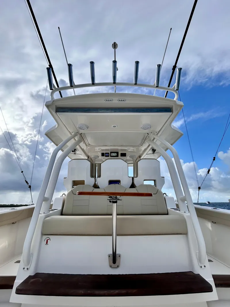 Slide: The Image of 2018 Pursuit S 368 Sport boat with fishing rods, under a cloudy sky. - 3