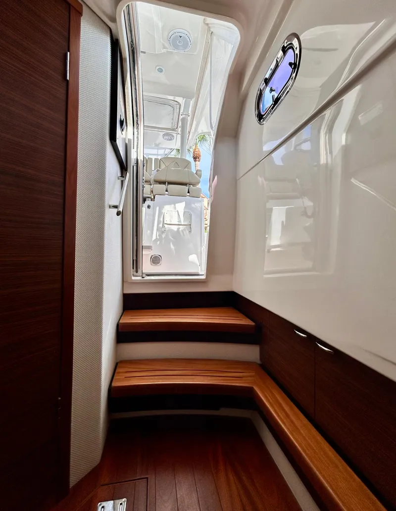 Slide: The Image of Interior view of 2018 Pursuit S 368 Sport boat with wooden steps and sleek design. - 5