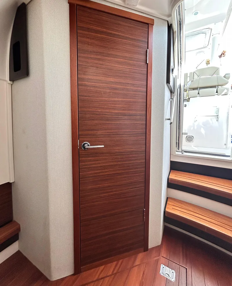 Slide: The Image of Interior of 2018 Pursuit S 368 Sport boat with wooden door and steps. - 6