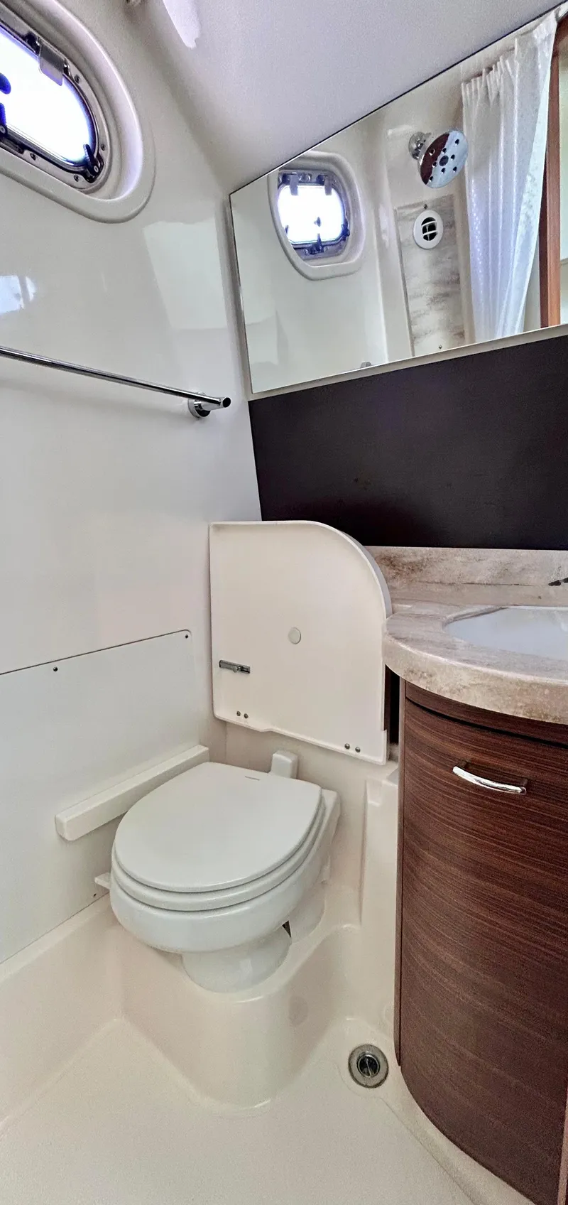 Slide: The Image of 2018 Pursuit S 368 Sport boat bathroom with toilet, sink, and mirror. - 7