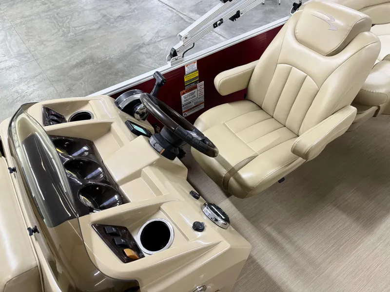 Slide: The Image of 2017 Bennington 21 SSRX boat interior with beige captain's chair and control panel. - 10