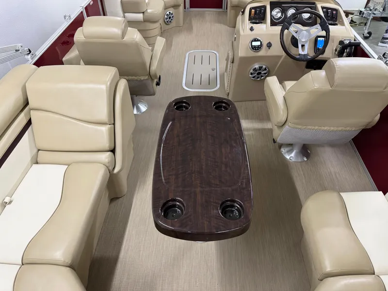 Slide: The Image of Interior of a 2017 Bennington 21 SSRX boat with beige seating and a wooden table. - 14