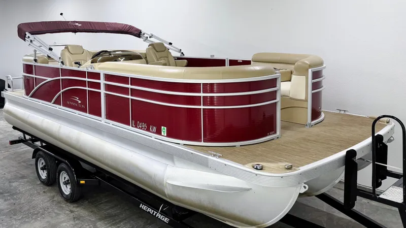 Slide: The Image of 2017 Bennington 21 SSRX pontoon boat with red exterior on a trailer in a garage. - 2