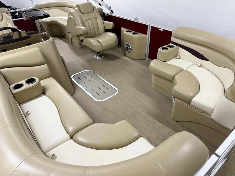 Slide: The Image of 2017 Bennington 21 SSRX boat interior with beige seating and cup holders. - 6