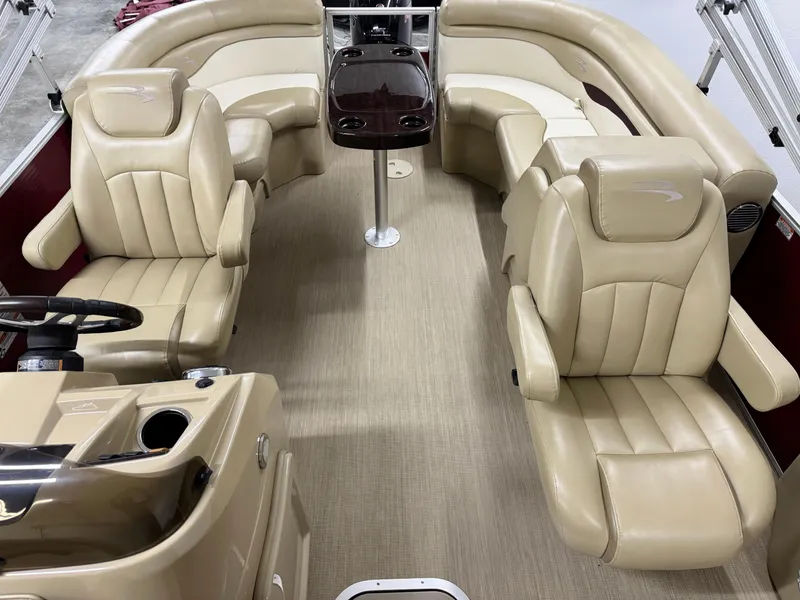 Slide: The Image of 2017 Bennington 21 SSRX pontoon boat interior with beige leather seating and steering console. - 7