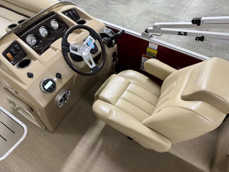 Slide: The Image of 2017 Bennington 21 SSRX boat helm with beige captain's chair and control panel. - 8