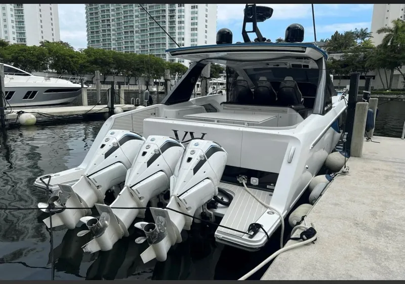 Slide: The Image of 2022 Azimut Verve 42 yacht docked in a marina, surrounded by palm trees. - 1