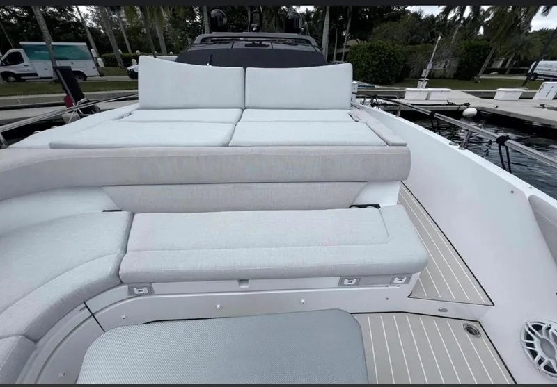 Slide: The Image of 2022 Azimut Verve 42 yacht interior with sleek table and cushioned seating. - 10