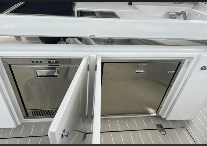 Slide: The Image of 2022 Azimut Verve 42 yacht interior with sleek seating and modern table design. - 13