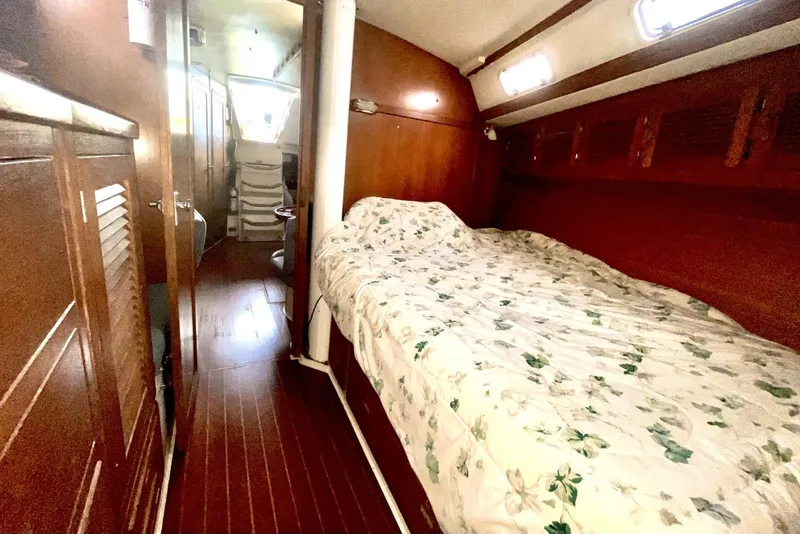 Slide: The Image of Interior cabin of 1992 Catalina 42 MK 1 sailboat with wooden finish and floral bedding. - 11