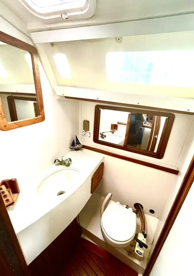 Slide: The Image of 1992 Catalina 42 MK 1 yacht bathroom with sink, mirror, and toilet. - 13