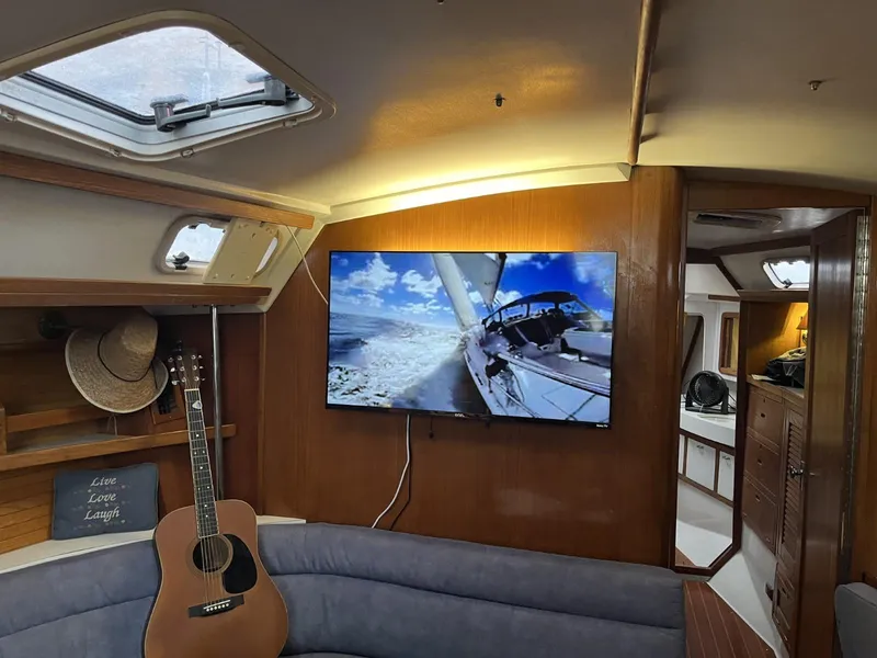 Slide: The Image of Interior of a 1992 Catalina 42 MK 1 sailboat with guitar and TV. - 17