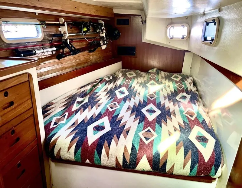 Slide: The Image of Cozy cabin interior of 1992 Catalina 42 MK 1 with patterned bedding and wooden accents. - 18