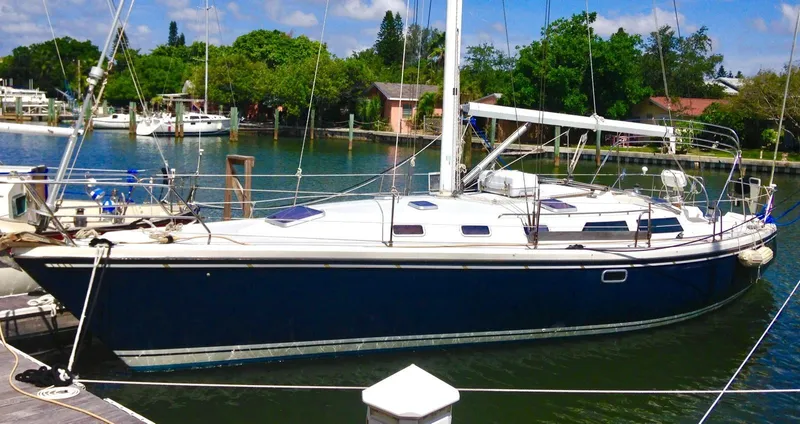 Slide: The Image of Sailboat Catalina 42 MK 1, 1992 model, docked in a serene marina setting. - 19