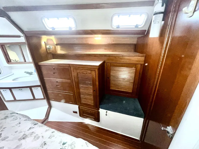 Slide: The Image of Interior of 1992 Catalina 42 MK 1 sailboat with wooden cabinetry and porthole windows. - 2